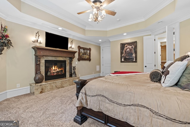 carpeted bedroom with a fireplace, ornamental molding, a raised ceiling, recessed lighting, and baseboards