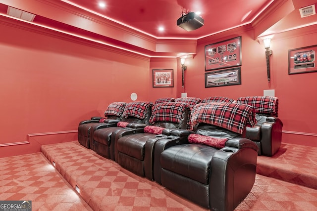 carpeted home theater room featuring ornamental molding