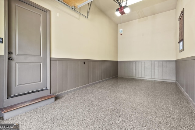 garage featuring a wainscoted wall and a garage door opener