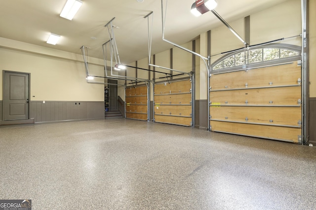 garage featuring a wainscoted wall and a garage door opener