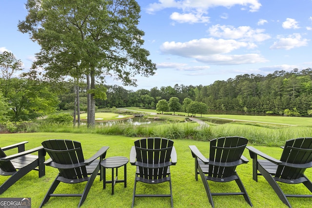 view of green lawn with a water view
