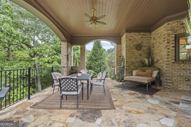 view of patio with outdoor dining space and ceiling fan
