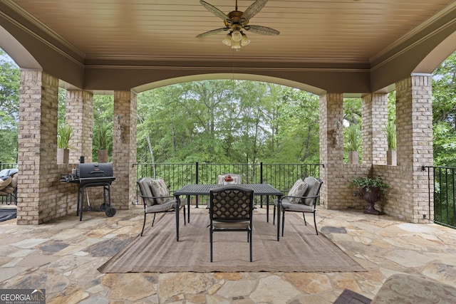 view of patio with outdoor dining space, a ceiling fan, and grilling area