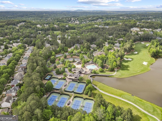 aerial perspective of suburban area with a golf course, a forest, and a nearby body of water