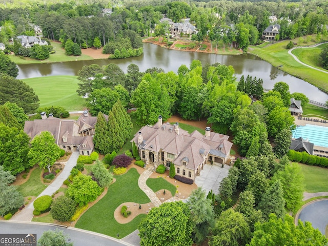 aerial view of a nearby body of water and a tree filled landscape