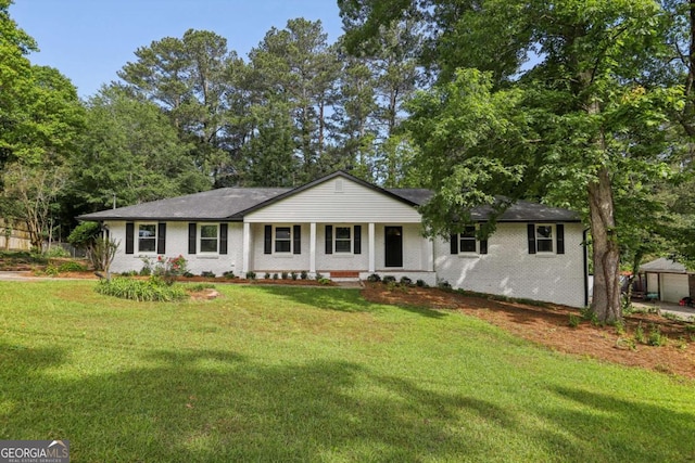 single story home featuring covered porch, a front yard, and brick siding