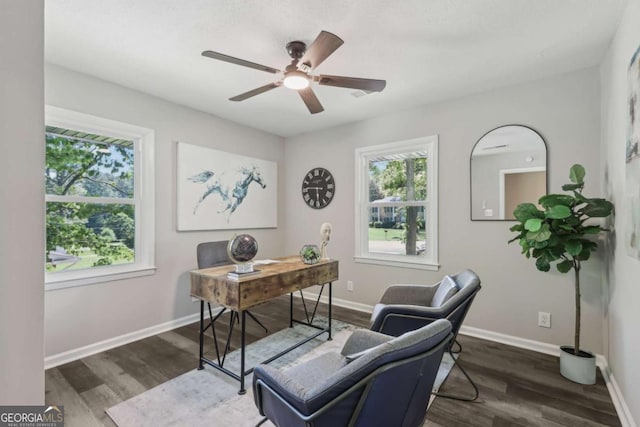 office area featuring dark wood-type flooring, ceiling fan, and baseboards