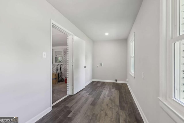 hallway featuring dark wood finished floors, plenty of natural light, baseboards, and recessed lighting
