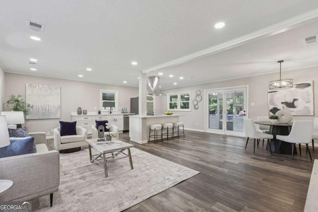 living room with dark wood finished floors, recessed lighting, ornamental molding, and baseboards