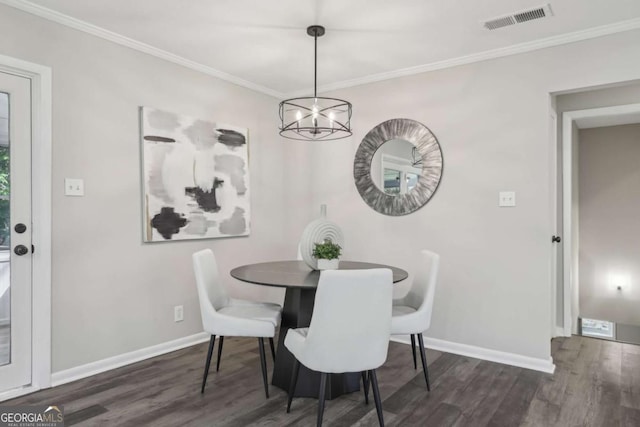dining room with wood finished floors, baseboards, a chandelier, and crown molding