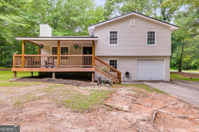 760 Poseyville Rd, Bremen, GA 30110 - tri-level home with concrete driveway, a chimney, a garage, stairway, and a porch