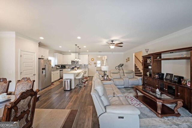 2209 Cedar Place Ct, Snellville, GA 30078 - living room featuring a ceiling fan, crown molding, dark wood-type flooring, stairs, and recessed lighting