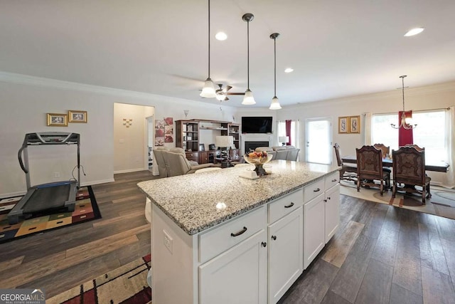 2209 Cedar Place Ct, Snellville, GA 30078 - kitchen featuring ornamental molding, a center island, dark wood-type flooring, white cabinets, and ceiling fan