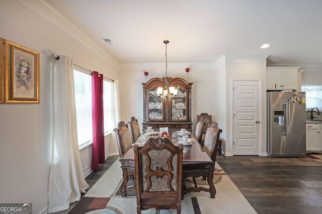 2209 Cedar Place Ct, Snellville, GA 30078 - dining area with a chandelier, dark wood-style floors, crown molding, recessed lighting, and baseboards