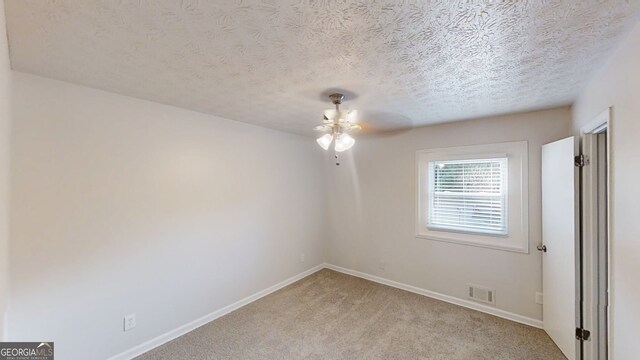3512 Valley Chase Ct, Lithonia, GA 30038 - spare room featuring ceiling fan, light colored carpet, baseboards, and a textured ceiling