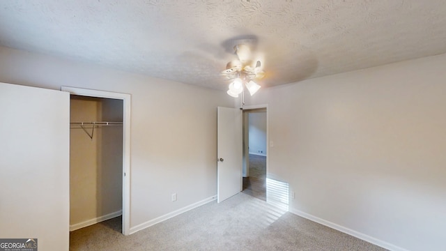 3512 Valley Chase Ct, Lithonia, GA 30038 - unfurnished bedroom featuring carpet flooring, baseboards, a textured ceiling, a closet, and ceiling fan