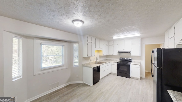3512 Valley Chase Ct, Lithonia, GA 30038 - kitchen with black appliances, a sink, light wood finished floors, a textured ceiling, and light countertops