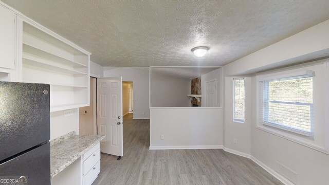 3512 Valley Chase Ct, Lithonia, GA 30038 - unfurnished dining area featuring light wood-style flooring and a textured ceiling