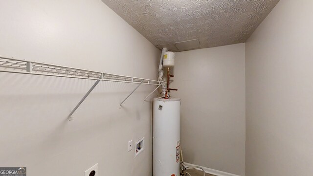 3512 Valley Chase Ct, Lithonia, GA 30038 - laundry area with water heater, washer hookup, electric dryer hookup, attic access, and a textured ceiling