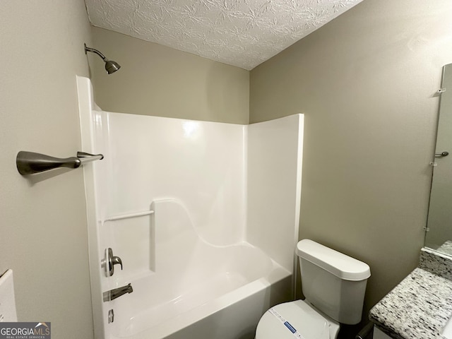9151 Jefferson Village Dr SW, Covington, GA 30014 - bathroom featuring toilet, a textured ceiling, and bathtub / shower combination