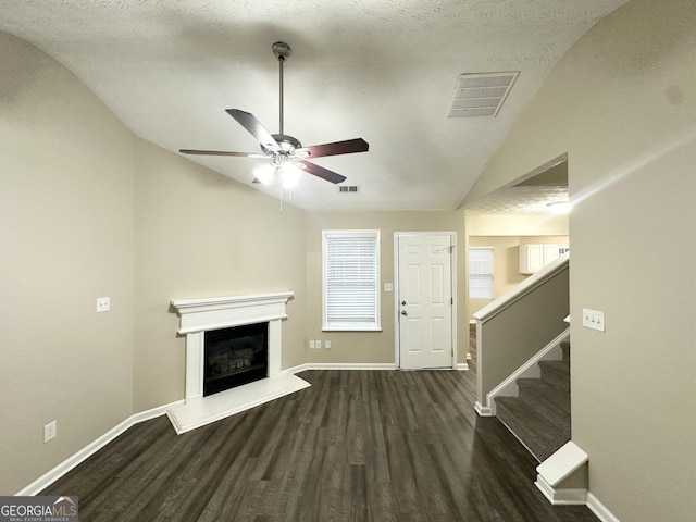 9151 Jefferson Village Dr SW, Covington, GA 30014 - unfurnished living room with lofted ceiling, wood finished floors, ceiling fan, baseboards, and a glass covered fireplace