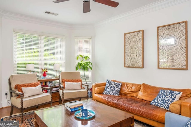 living room featuring ceiling fan, crown molding, and wood finished floors