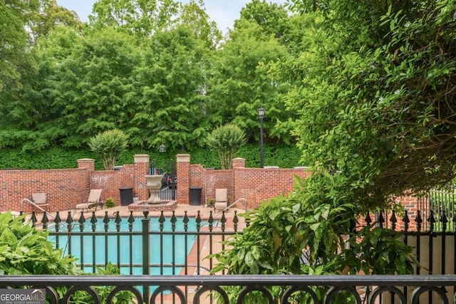view of pool with fence and a patio