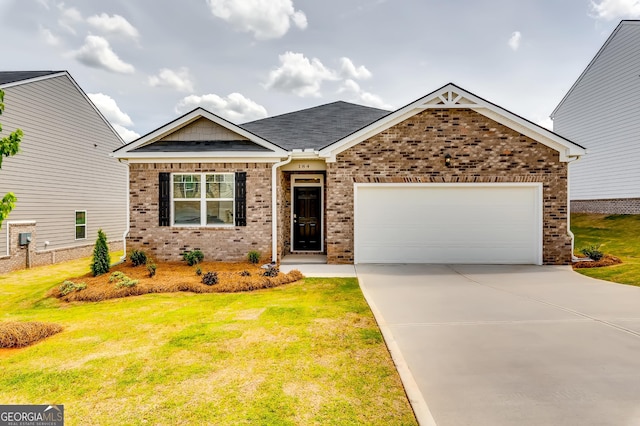 view of front of house with brick siding, driveway, a front yard, and an attached garage