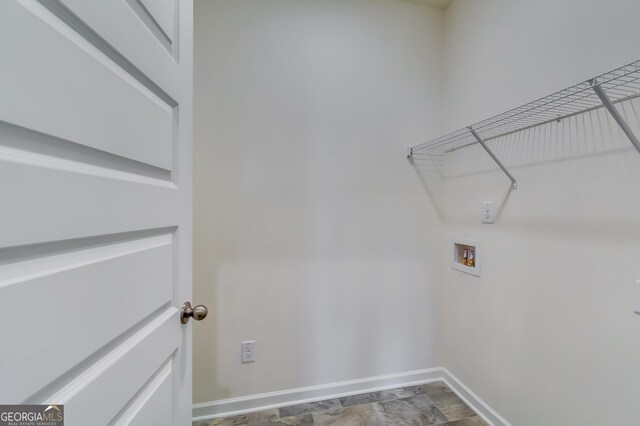 laundry area featuring hookup for a washing machine and baseboards
