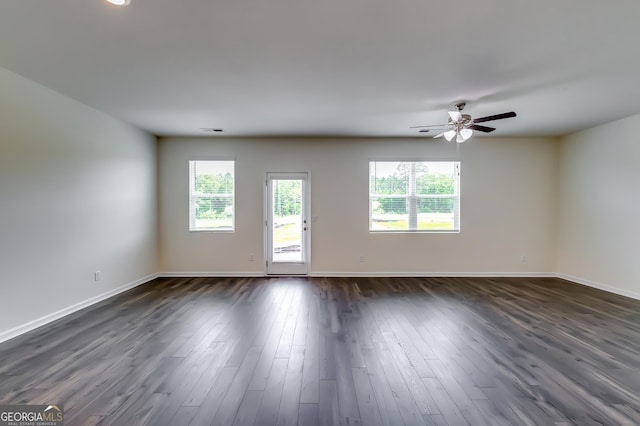 unfurnished living room featuring ceiling fan, baseboards, and dark wood finished floors