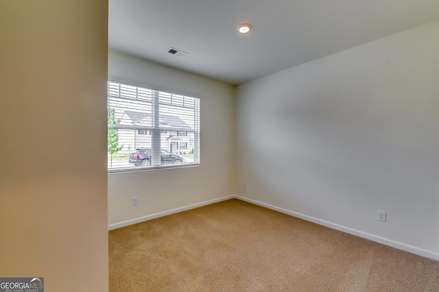 unfurnished room with baseboards and carpet floors