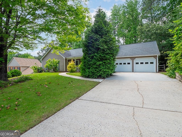 view of front of house featuring concrete driveway, a front yard, and an attached garage