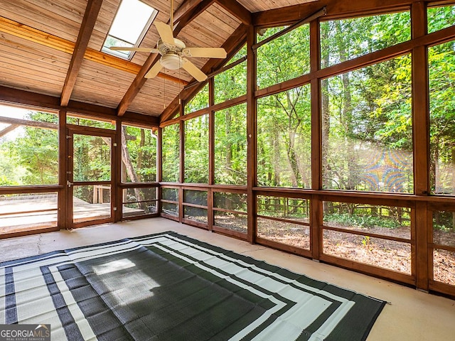 unfurnished sunroom with a ceiling fan and a skylight