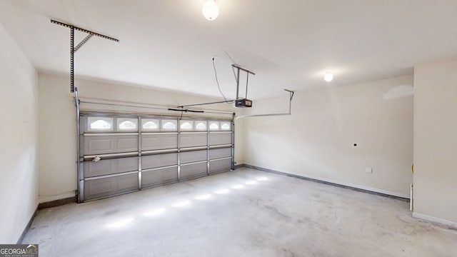 900 Ellesmere Pt, Mcdonough, GA 30253 - garage featuring a garage door opener and baseboards
