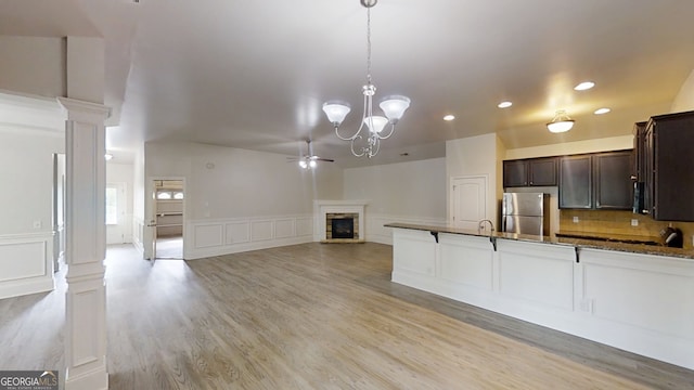 900 Ellesmere Pt, Mcdonough, GA 30253 - kitchen with freestanding refrigerator, dark brown cabinetry, recessed lighting, pendant lighting, and a decorative wall