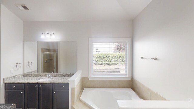 900 Ellesmere Pt, Mcdonough, GA 30253 - full bathroom featuring vanity, a bath, and a shower stall