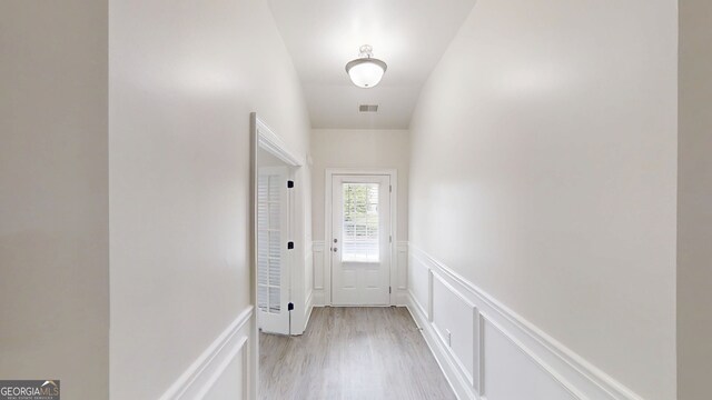 900 Ellesmere Pt, Mcdonough, GA 30253 - entryway featuring a decorative wall, wainscoting, and light wood-style floors