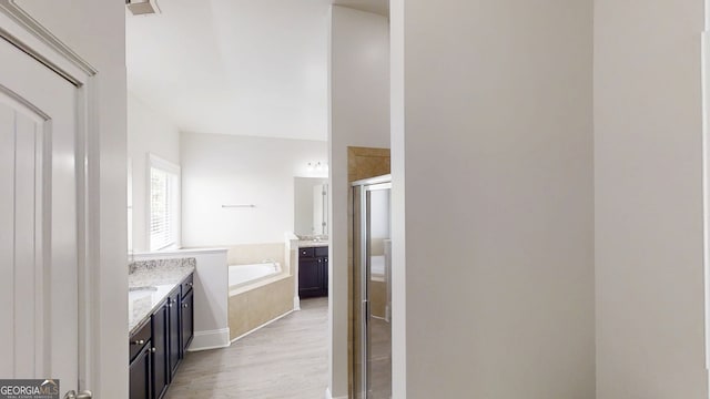 900 Ellesmere Pt, Mcdonough, GA 30253 - bathroom featuring a shower stall, a garden tub, wood finished floors, and vanity