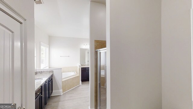 900 Ellesmere Pt, Mcdonough, GA 30253 - bathroom with a shower stall, wood finished floors, vanity, and a garden tub