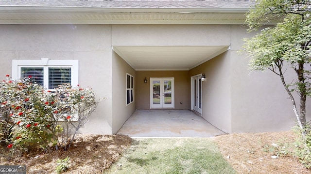 900 Ellesmere Pt, Mcdonough, GA 30253 - view of exterior entry with french doors, a shingled roof, stucco siding, and a patio area