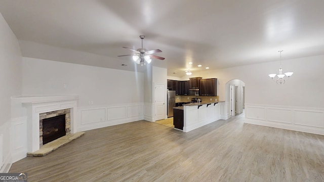900 Ellesmere Pt, Mcdonough, GA 30253 - kitchen with open floor plan, stainless steel appliances, arched walkways, a ceiling fan, and a decorative wall