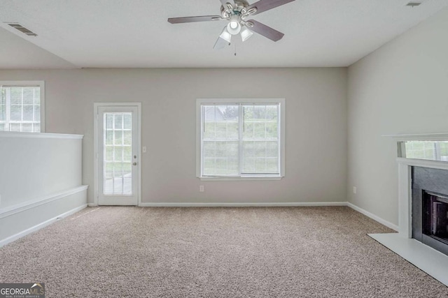 4889 Hidden Creek Pl, Decatur, GA 30035 - unfurnished living room with carpet flooring, a high end fireplace, plenty of natural light, and a ceiling fan