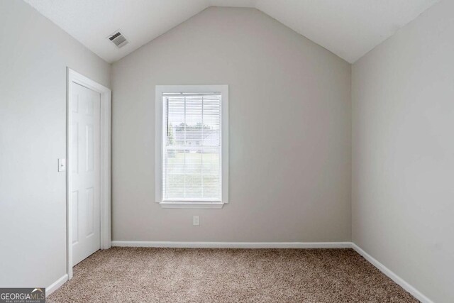 4889 Hidden Creek Pl, Decatur, GA 30035 - unfurnished bedroom featuring carpet floors and lofted ceiling