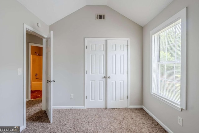 4889 Hidden Creek Pl, Decatur, GA 30035 - unfurnished bedroom featuring carpet, a closet, and vaulted ceiling