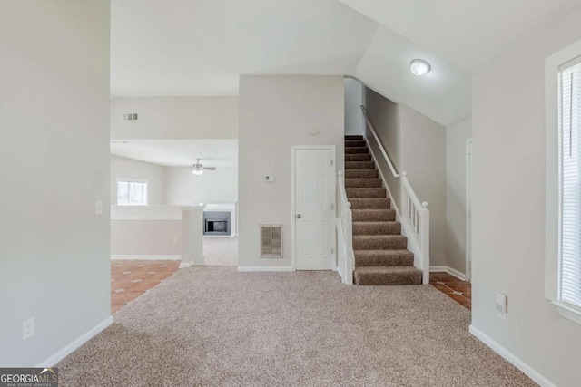 4889 Hidden Creek Pl, Decatur, GA 30035 - unfurnished living room featuring carpet, stairs, a ceiling fan, and a fireplace