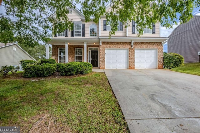 8826 Lakecrest Way, Union City, GA 30291 - view of front of house with brick siding, concrete driveway, a garage, a front yard, and covered porch