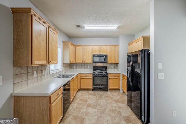 8826 Lakecrest Way, Union City, GA 30291 - kitchen featuring black appliances, light brown cabinets, tasteful backsplash, light countertops, and a textured ceiling
