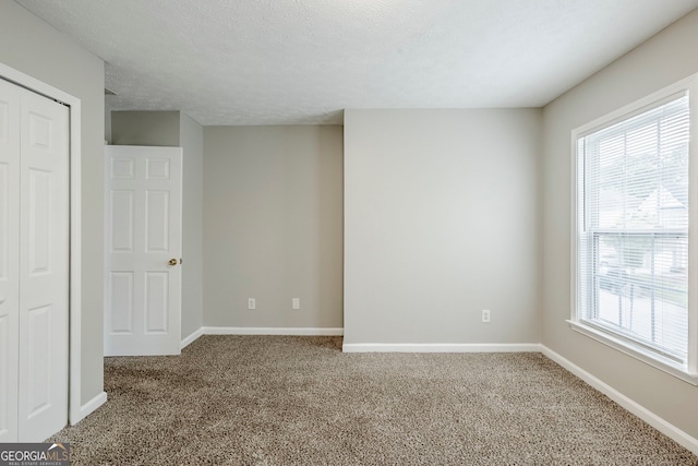 8826 Lakecrest Way, Union City, GA 30291 - unfurnished room featuring carpet flooring, healthy amount of natural light, and a textured ceiling