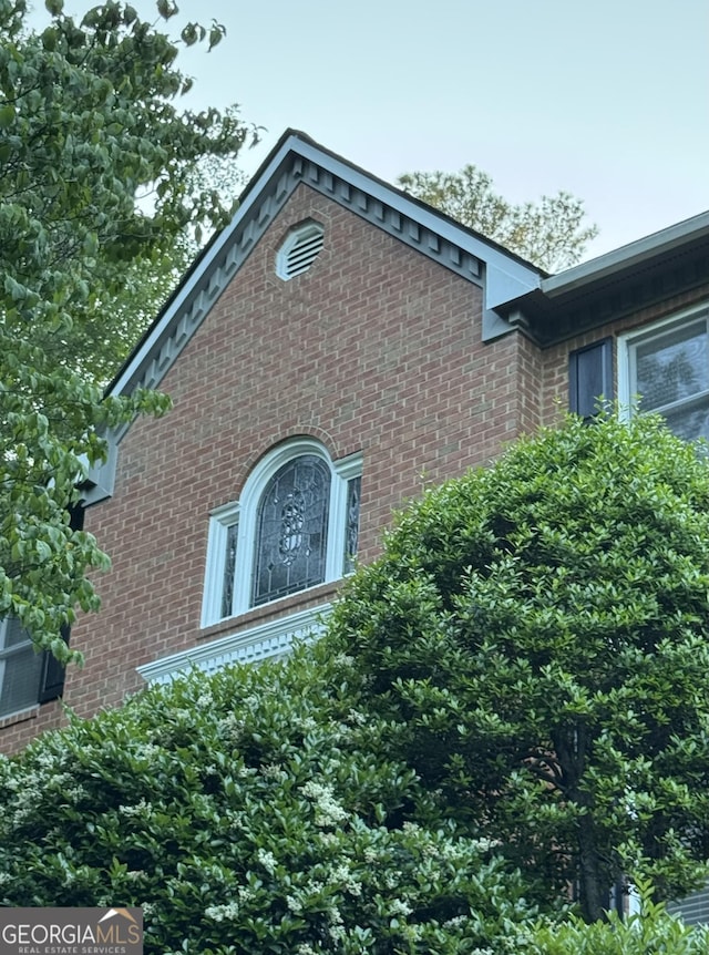 view of property exterior featuring brick siding