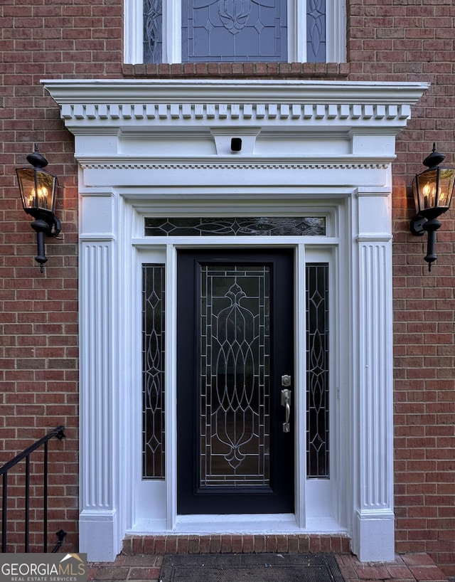 property entrance featuring brick siding